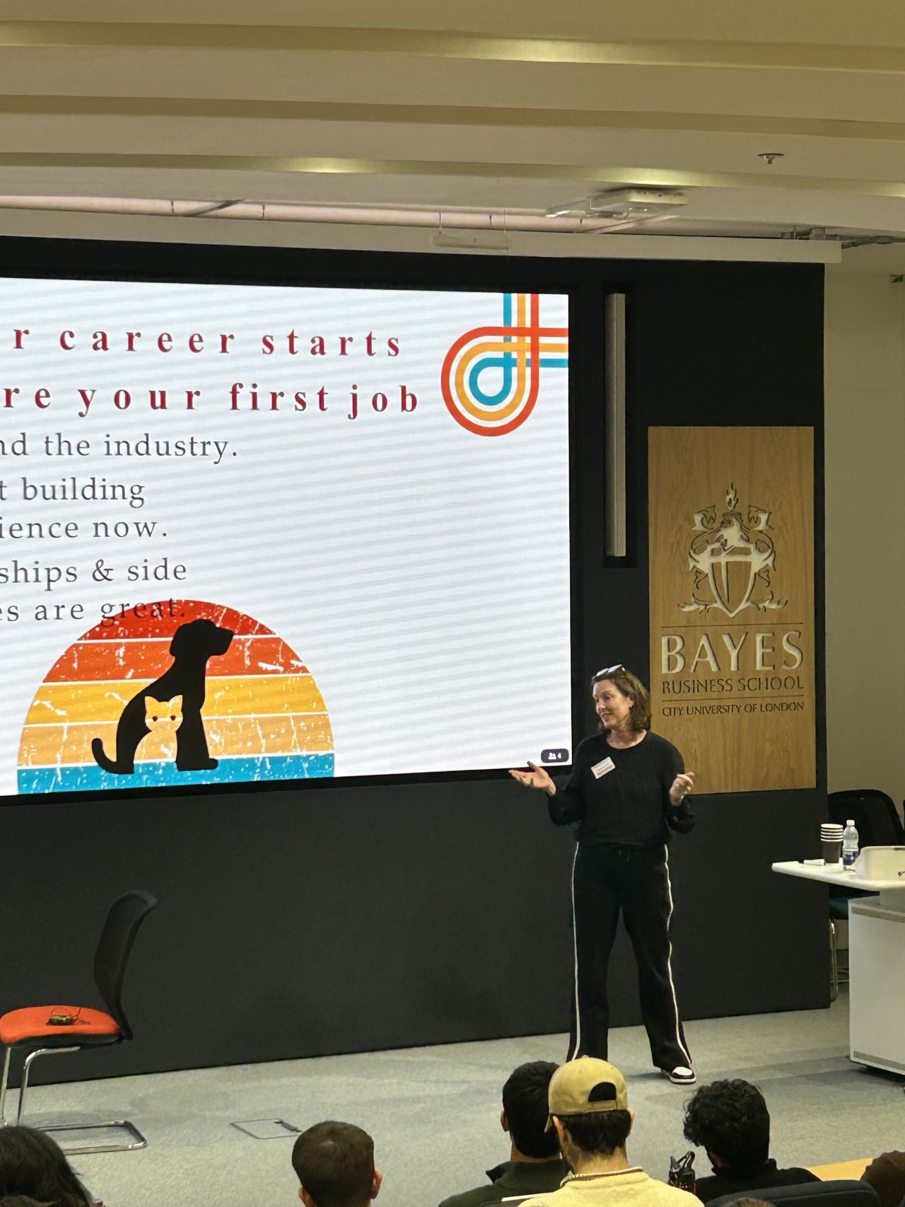 Sandra Peat speaking on stage at Bayes Business School